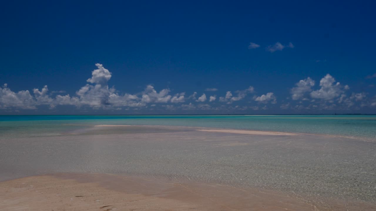 Pink sands, the most beautiful tropical beach of the atoll of Fakarava, French Polynesia  with crystal clear water of the blue lagoon in the background