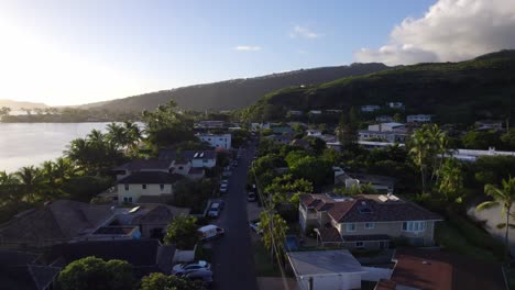 drone footage thru the coastal region of honolulu hawaii showing the residential and commercial areas nestled within the lush mountains