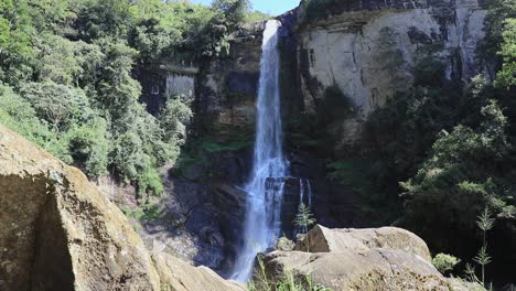 Ramboda-Falls-static-camera-angle-view-from-distance-slow-motion-b-roll-clip,-steady-stream-of-water-falling-109m-long-way-down