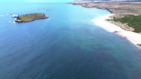 aerial-view-of-rugged-coast-line-with-blue-ocean-and-waves-crashing,-portugal,-4k