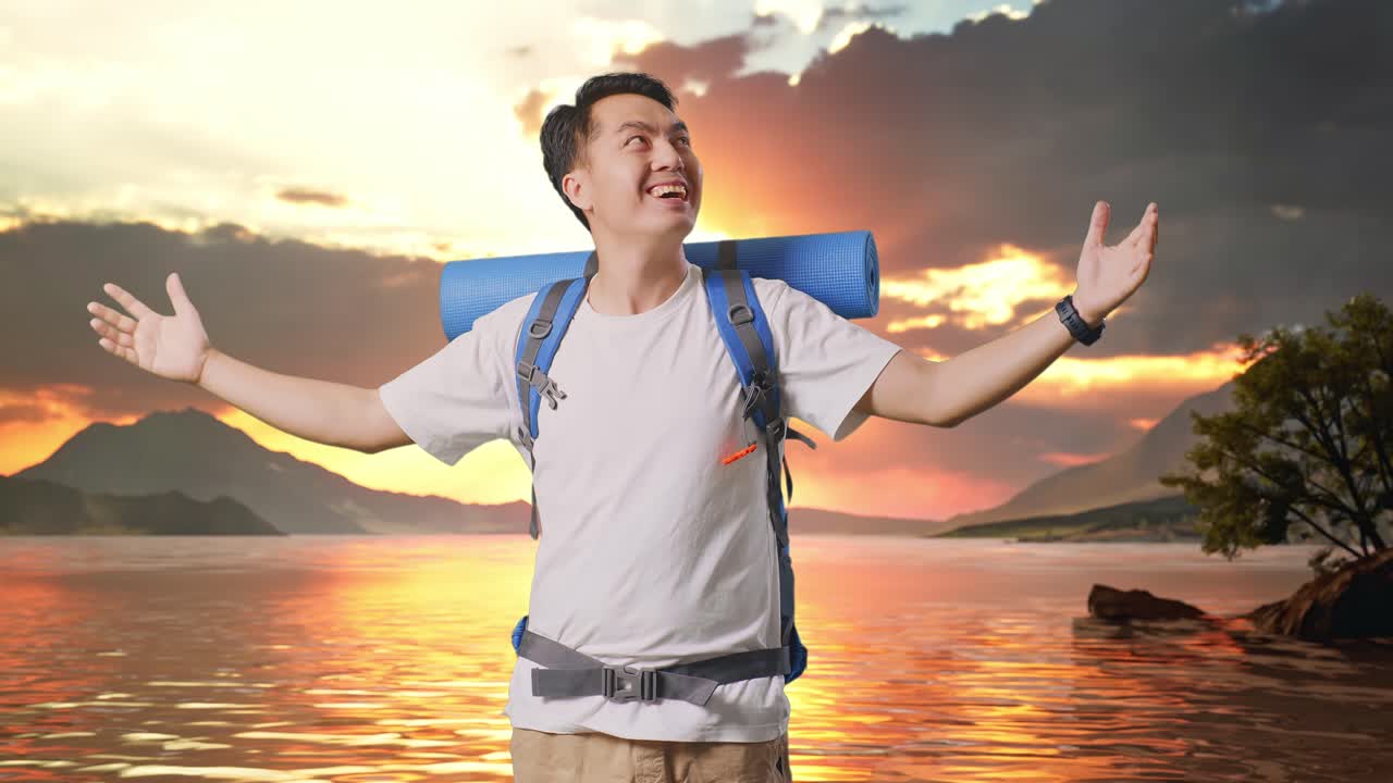 Asian Male Hiker With Mountaineering Backpack Smiling And Spreading Arms Enjoy Looking The View Around At A Lake