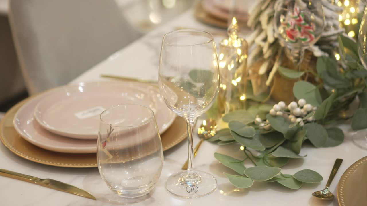 Close-up of an elegant festive table with warm decorations and Christmas lighting. 4k.
