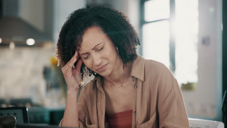 stressed woman working from home at her kitchen table