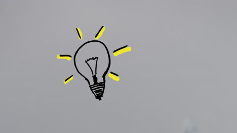 Animation-of-drawing-of-light-bulb-with-blinking-yellow-rays-over-white-background