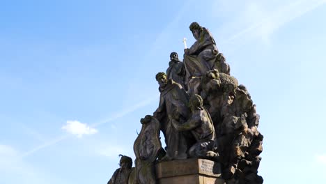 statues of john of matha, felix of valois and saint ivan on charles bridge in prague, czech republic