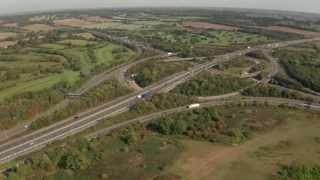 rising aerial slider shot over m25 m11 motorway road interchange essex