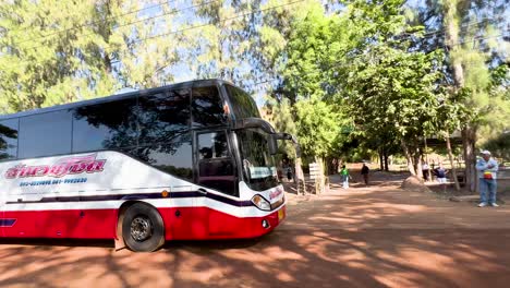 bus approaches scenic park entrance in thailand