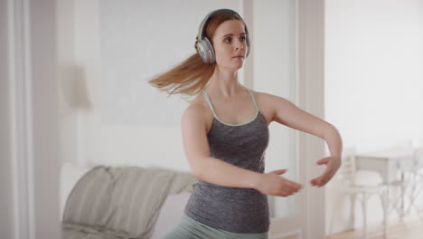 beautiful woman dancing practicing ballet dancer rehearsing at home with graceful dance moves wearing headphones listening to music 4k