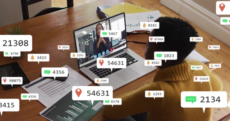 Analyst launching web call greeting colleague animated metrics overlaying laptop business meeting