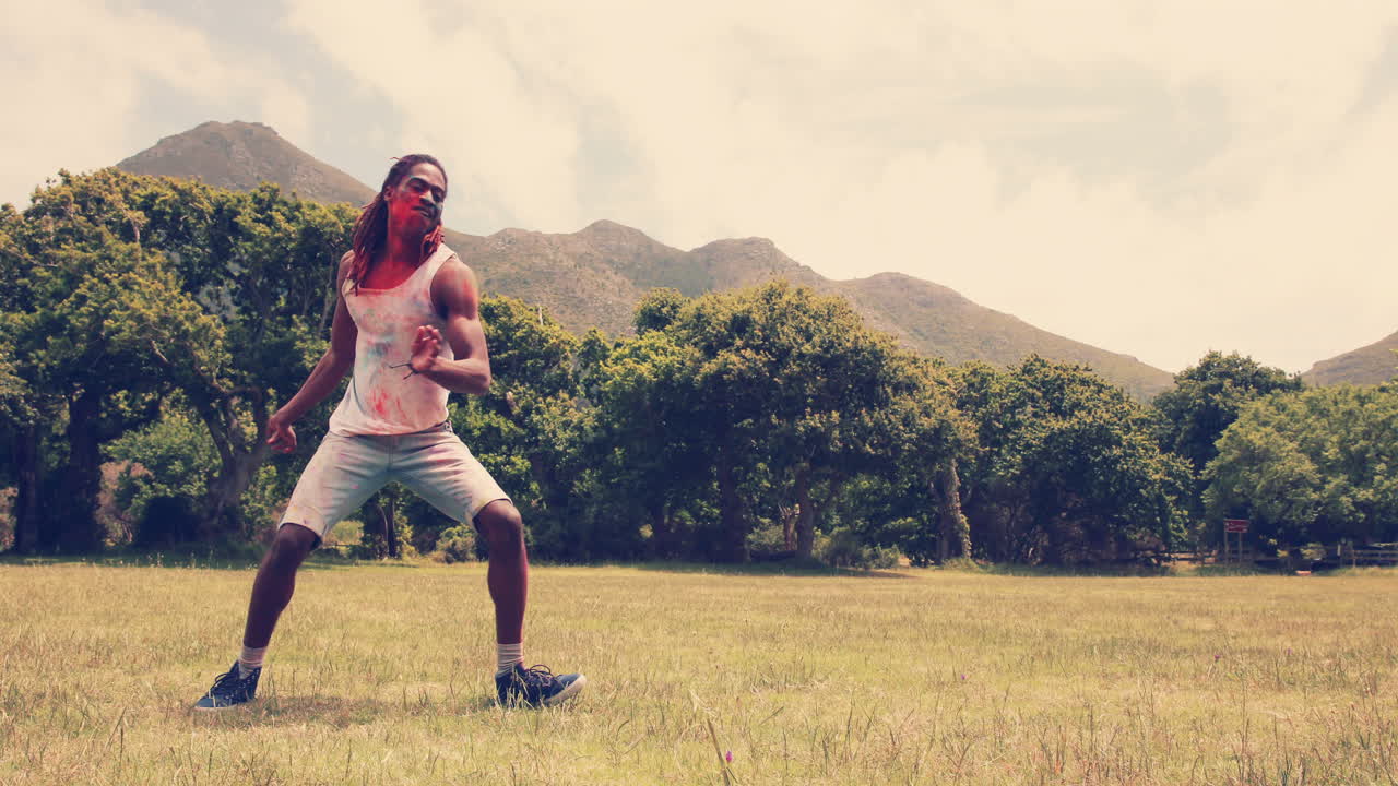 Young man with powder paint having fun 