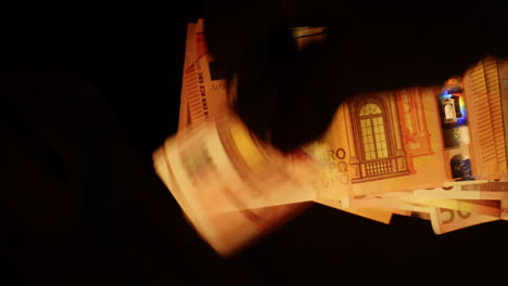 black gloved hands showing and counting european bills of money