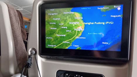 airplane cabin with flight map display