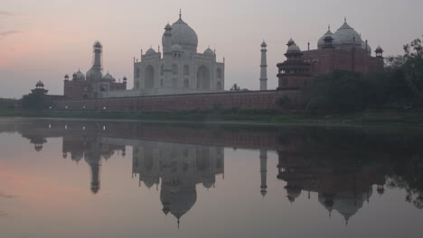 taj mahal at sunrise, reflected on the river