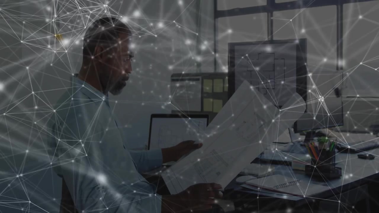 Male engineer lifting blueprint, angling and inspecting pages while animated overlay guides review