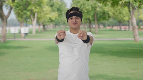 happy indian man doing wrist exercise