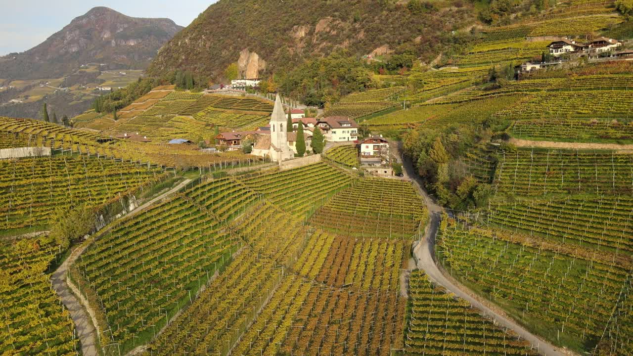 Aerial Drone Over a medieval church in the middle of the Vineyards in Autumn in South Tyrol, St