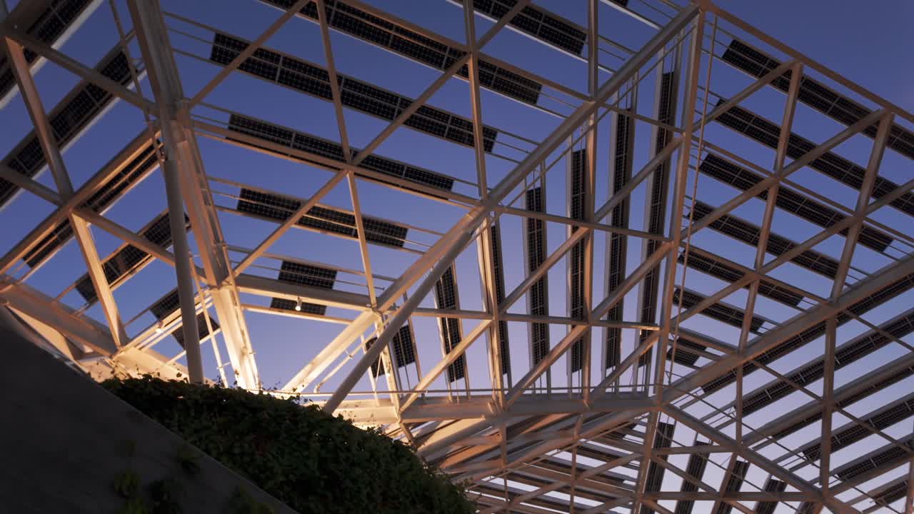Gimbal rotating and panning shot of the futuristic solar panel canopy at the Nvidia headquarters during twilight in Santa Clara, California. 4K