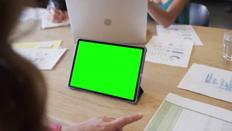 mujer de negocios caucásica en una videollamada de tableta con pantalla verde
