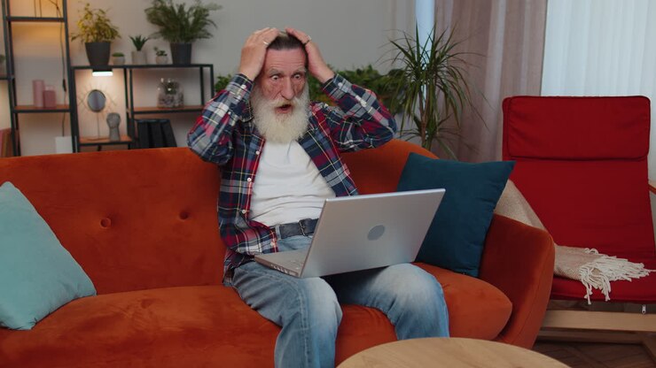 Overjoyed senior man working on laptop celebrate success win money in lottery get online good news