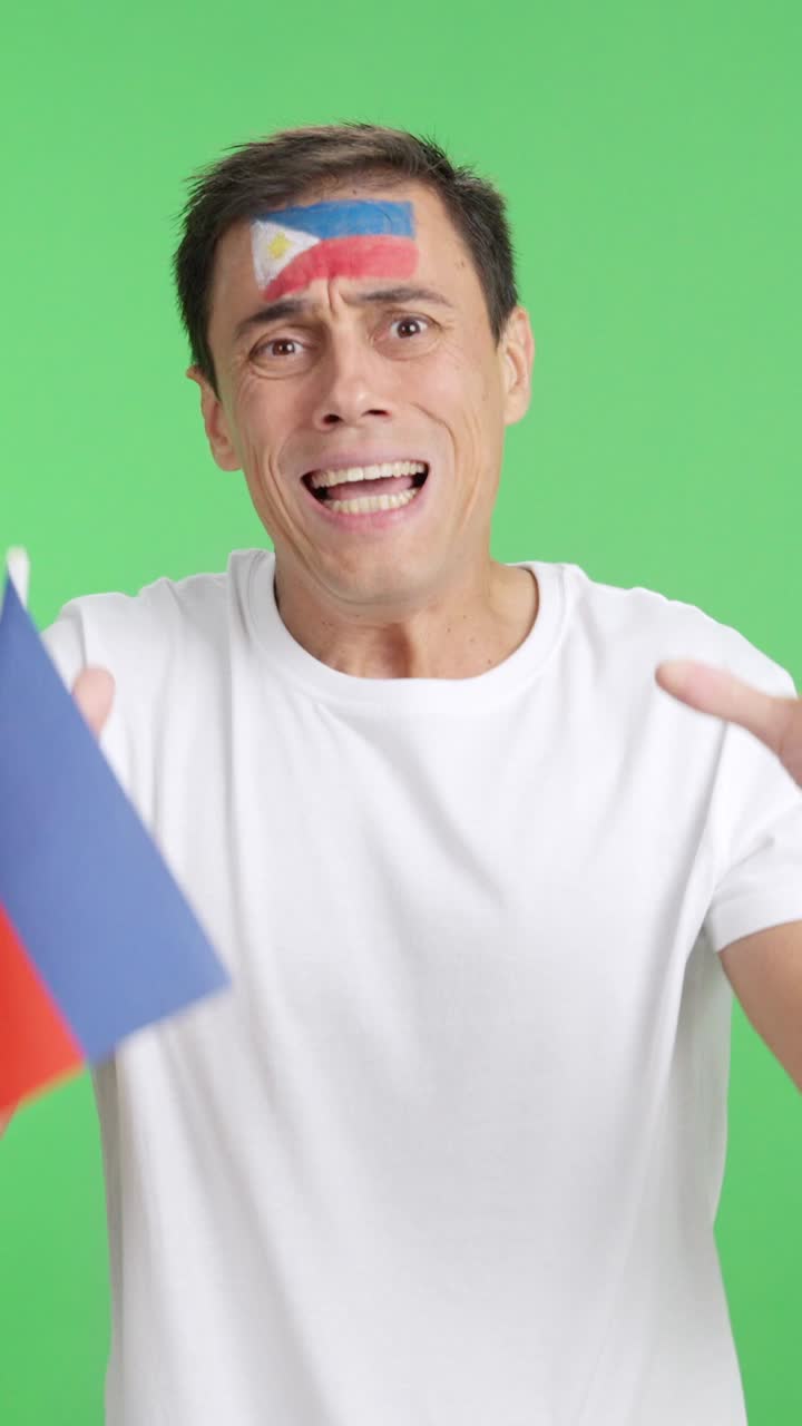Man cheering for Philippines during a match that is lost