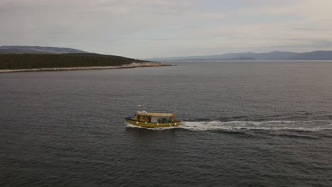 Fishing-boat-sailing,-island-in-background