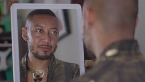 man looking at himself in a mirror