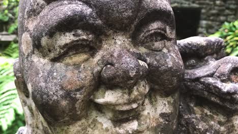 details of a grungy laughing buddha head sculpture - extreme close up