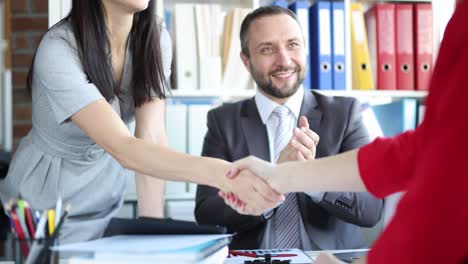 successful business people shake hands when finishing meeting