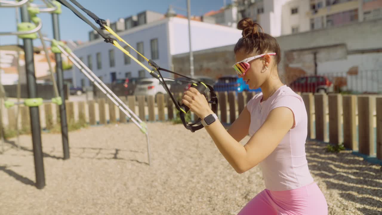 Woman Doing Suspension Training in a Park