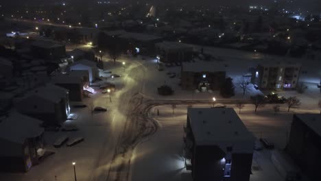 snowy night in st-sauveur, quebec, with snow-covered streets and bright lights.