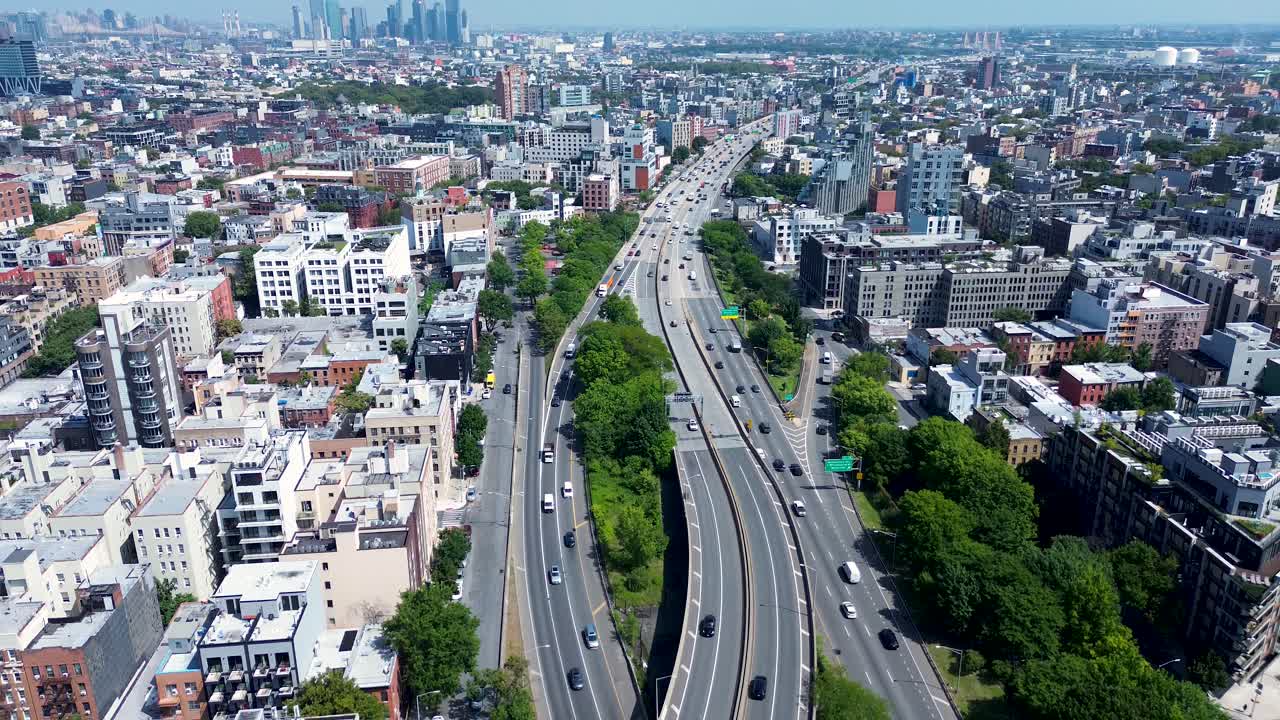 Drone aerial landscape of cars transport traffic driving along freeway highway road town of Williamsburg city suburb of Brooklyn New York USA America transport urban infrastructure