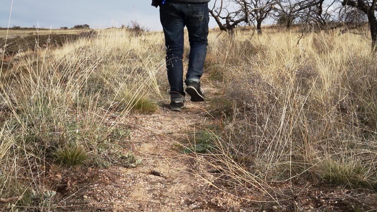 Slow Motion | Male hiking with jeans at grass land of Cappadocia, Turkey | Silk Road