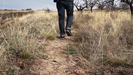 slow motion | male hiking with jeans at grass land of cappadocia, turkey | silk road