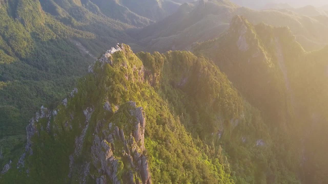 dando vueltas sobre los escarpados picos de las montañas revela un glorioso amanecer radiante que llena el brumoso horizonte