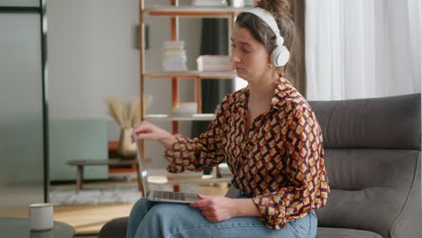 woman has argument in virtual meeting and closes laptop, side view