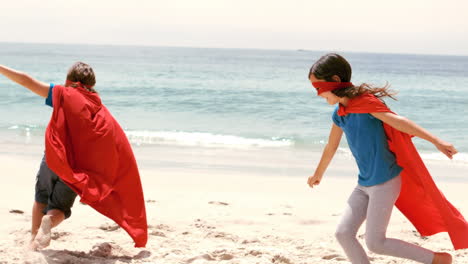 smiling children dressed as superman