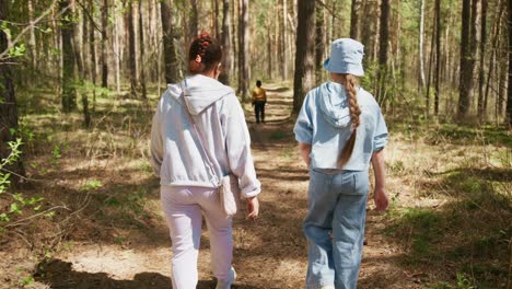 girls walking in a forest