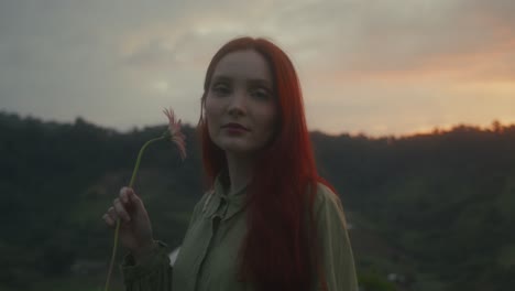 woman with a flower at sunset