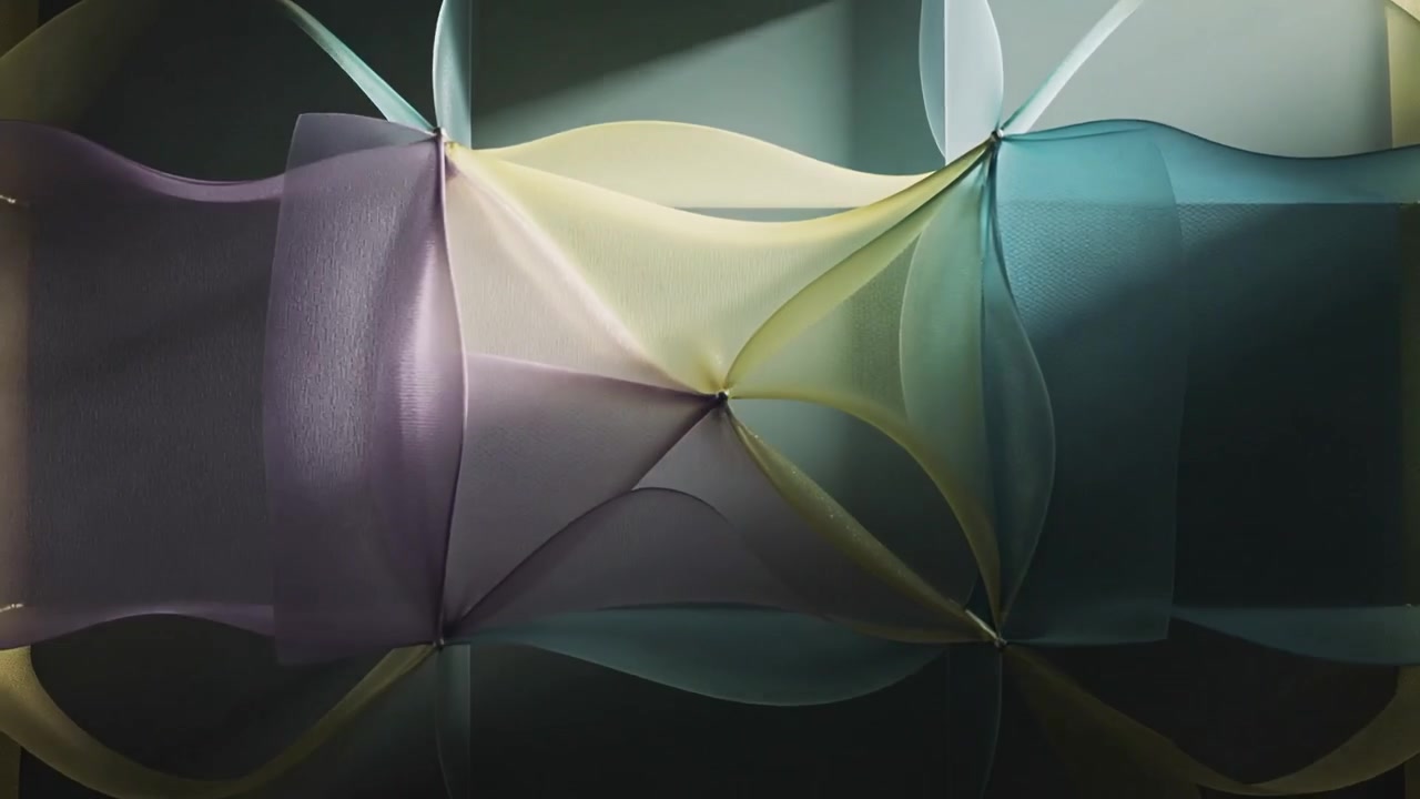 Tie points releasing, causing sheer panels lifting and rippling in studio, showing pastel hues