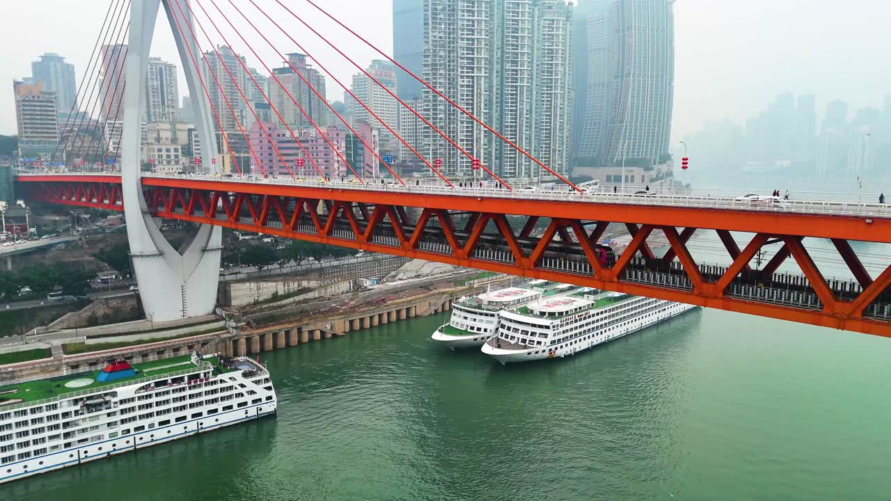 Pan drone shot of the Twin River Bridges with train and cars above Yangtze River during the day in Chongqing, Yuzhong District, China