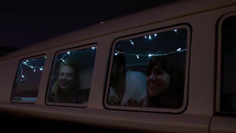 group of friends laughing in a camper van 4k