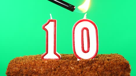 cake with the number 10 lighted candle. chroma key. green screen. isolated