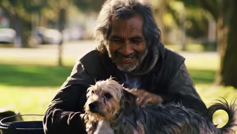 a heartwarming moment of bonding: an elderly man joyfully cares for his beloved dog in a sunny park, sharing laughter and affection together
