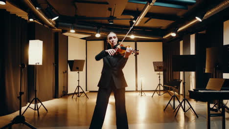 woman playing the violin in a concert hall