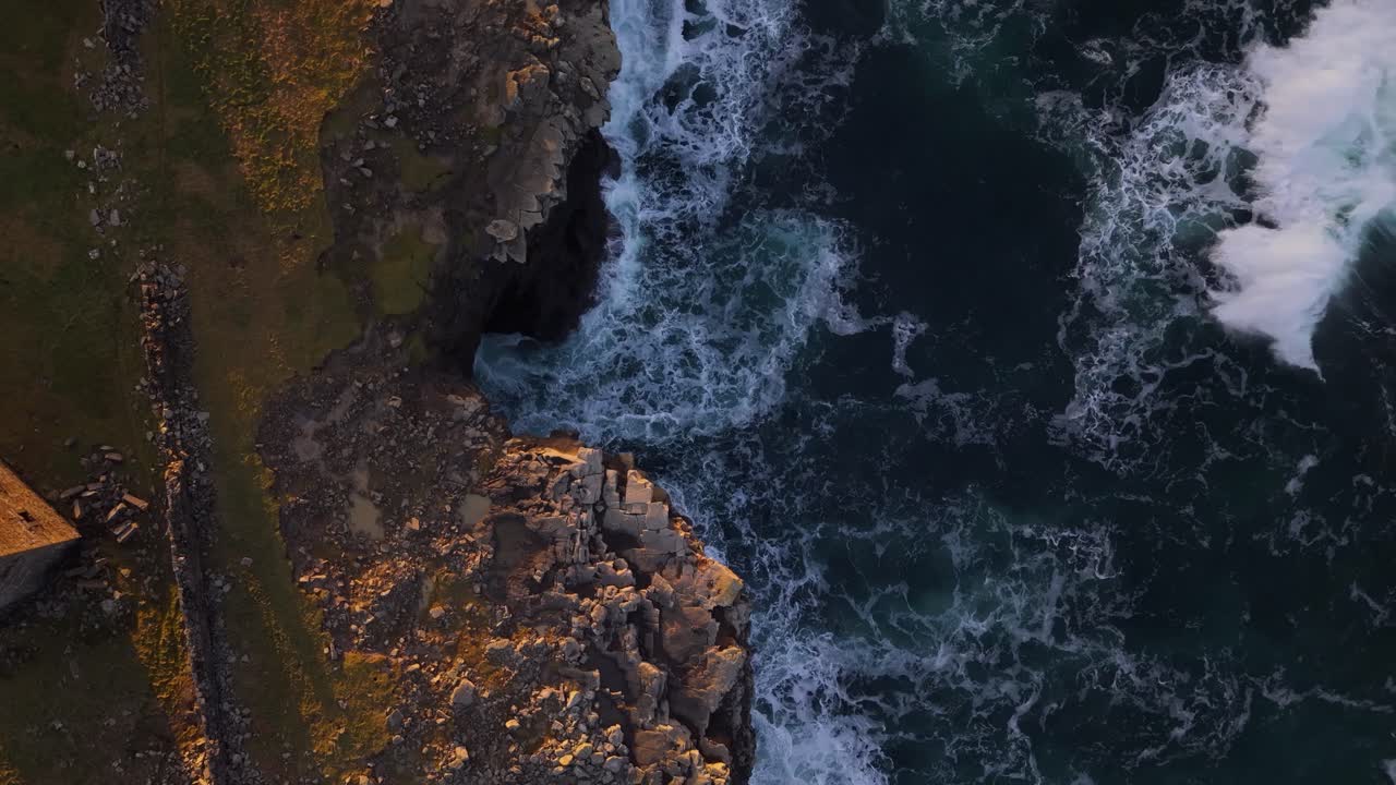 Mutton Island cliffs with ocean waves in County Clare, Ireland