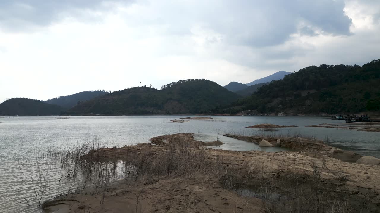 Scenic Mountain Lake with Fishing Nets and Boats
