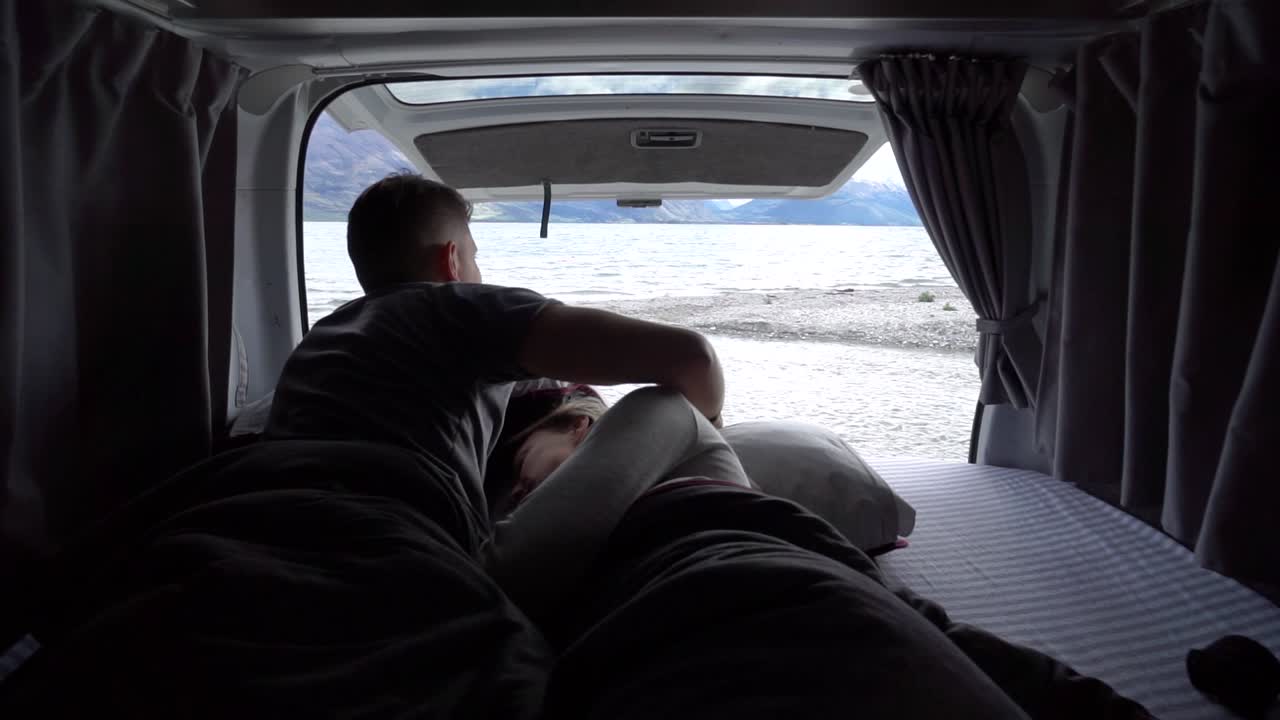 Couple Enjoying Scenic Lake and Mountain View from Camper Van