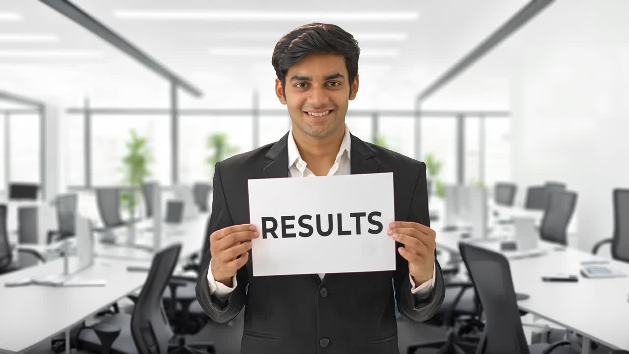 Happy Indian manager holding RESULTS banner