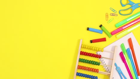 vibrant school stationery move on right side of yellow theme. stop motion