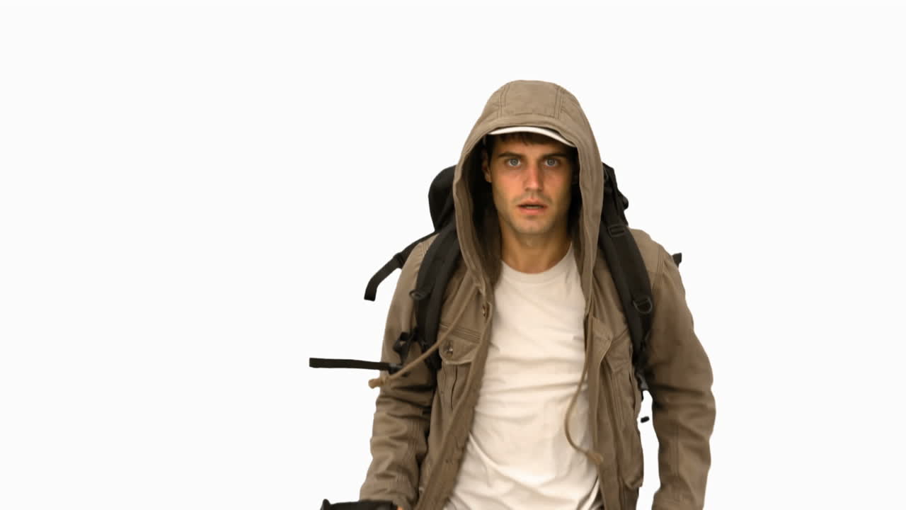 Man with a coat and a hiking stick running on white screen
